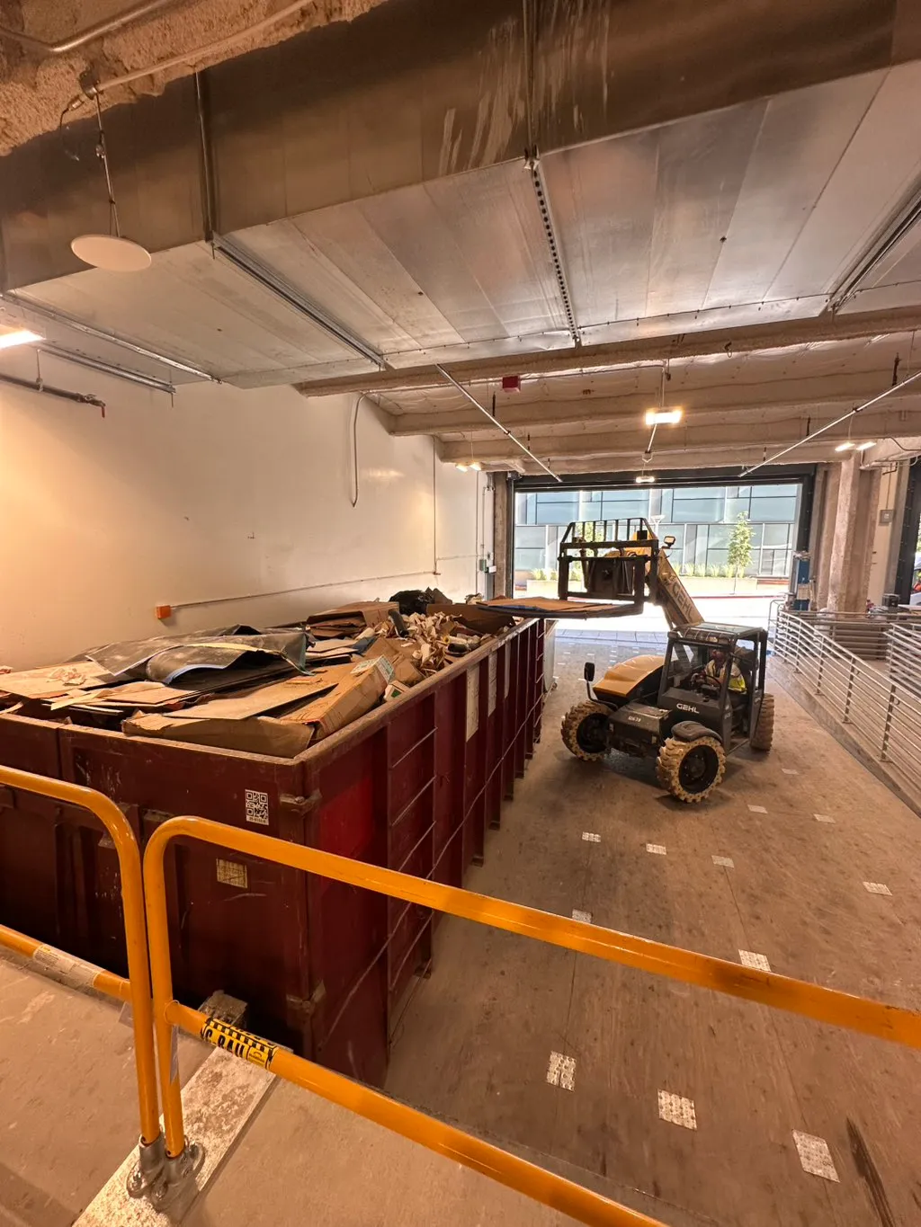 Commercial parking garage with a debris container during a tenant improvement