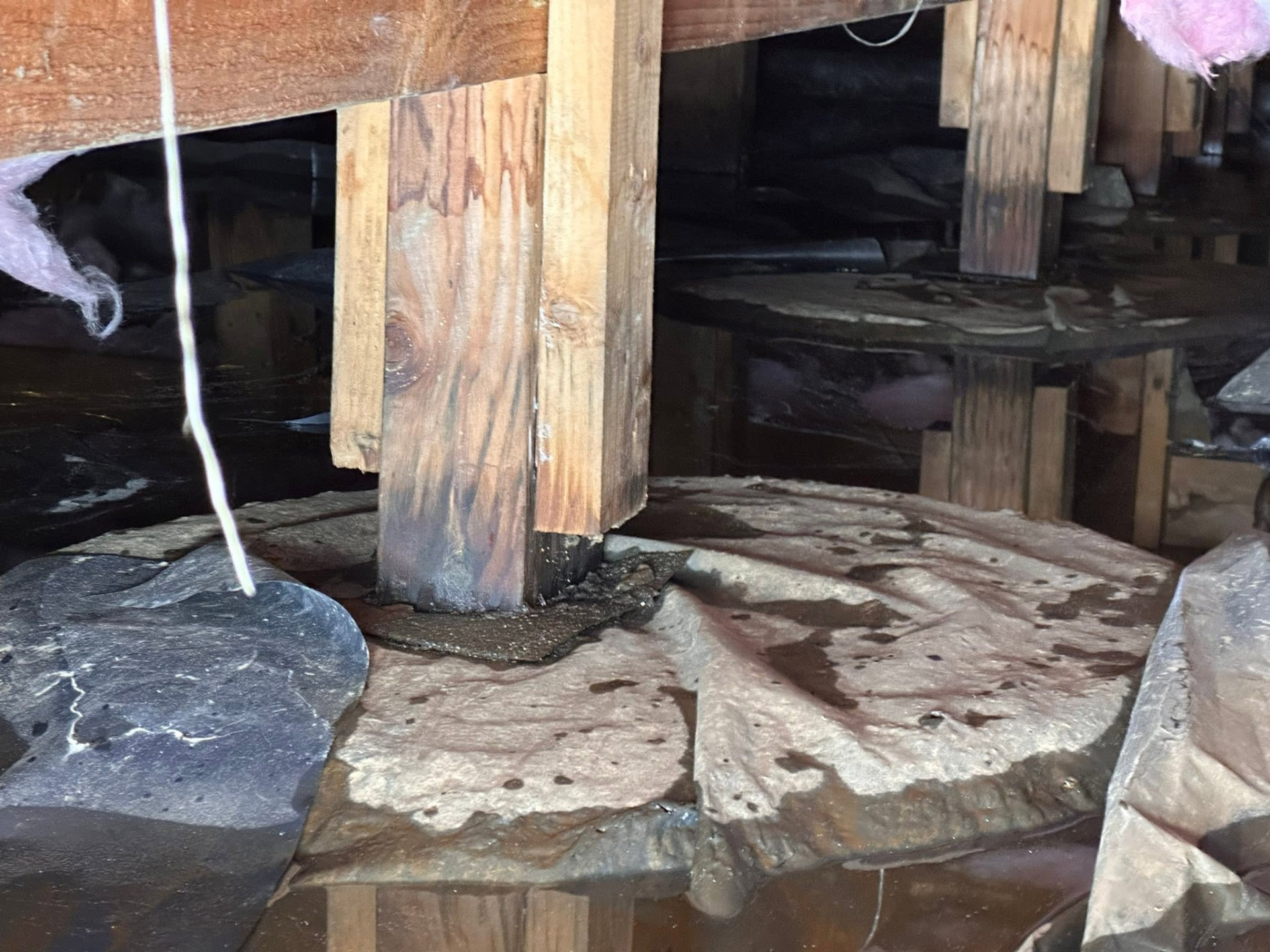 Crawlspace post and footing checked after water removal