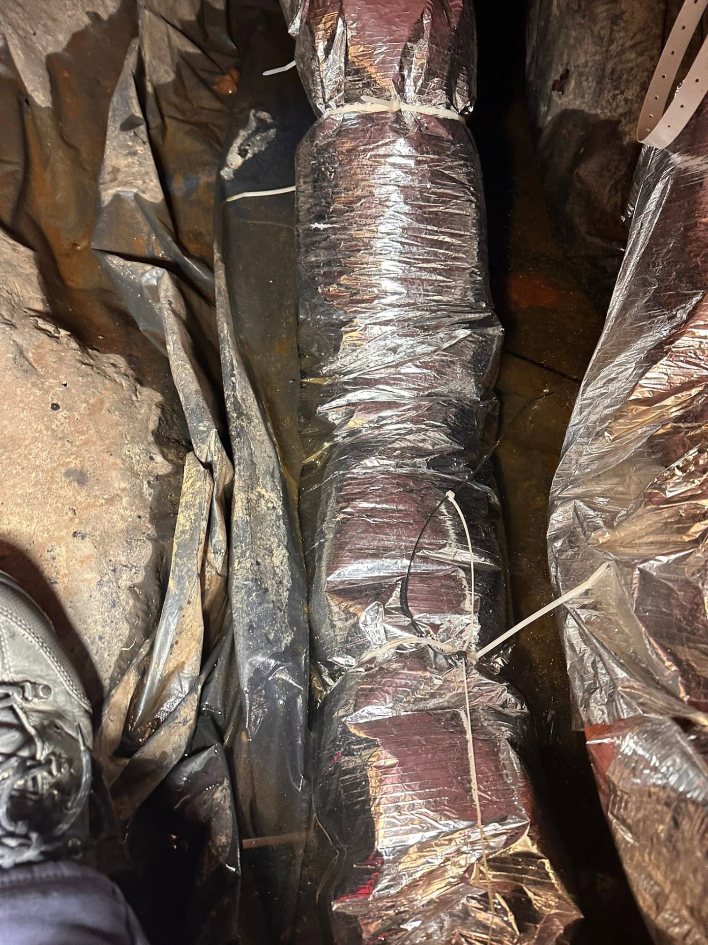Crawlspace duct runs wrapped and sealed after restoration