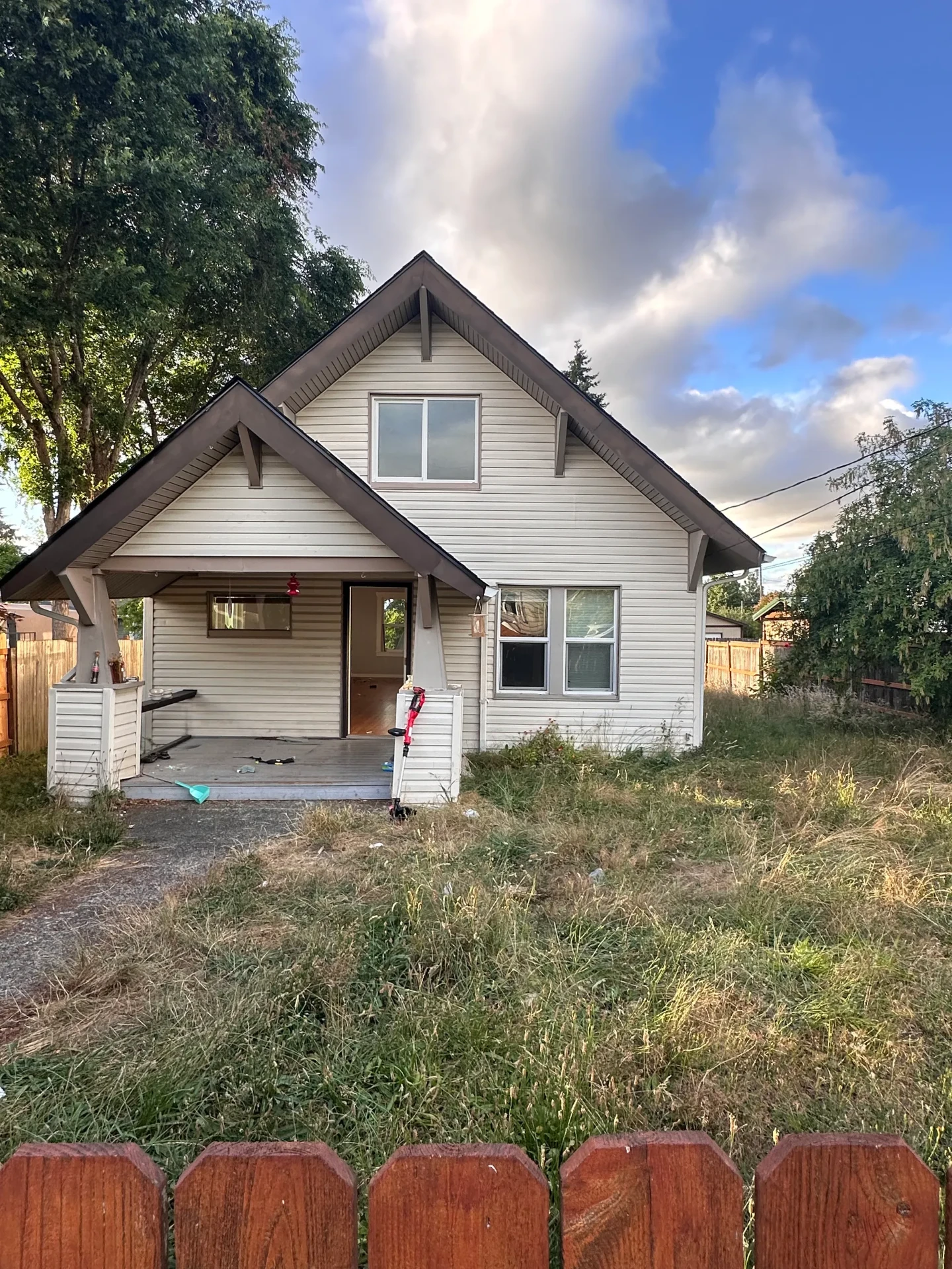 Overgrown yard and stripped porch at a property turnover