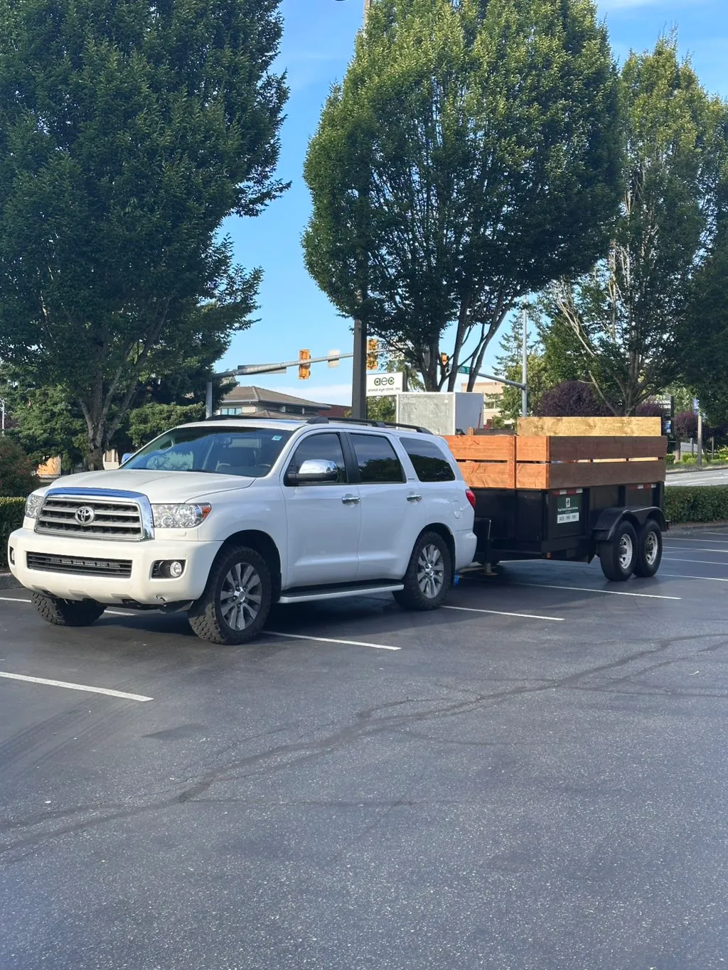White Toyota Sequoia towing the PSPS dump trailer in a Bellevue parking lot